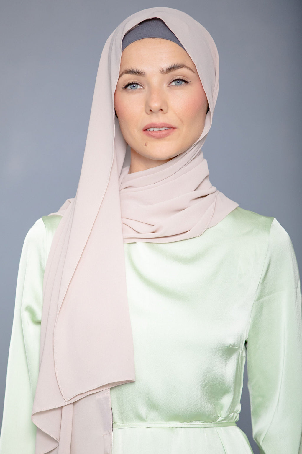 Woman in latte chiffon hijab and light green dress