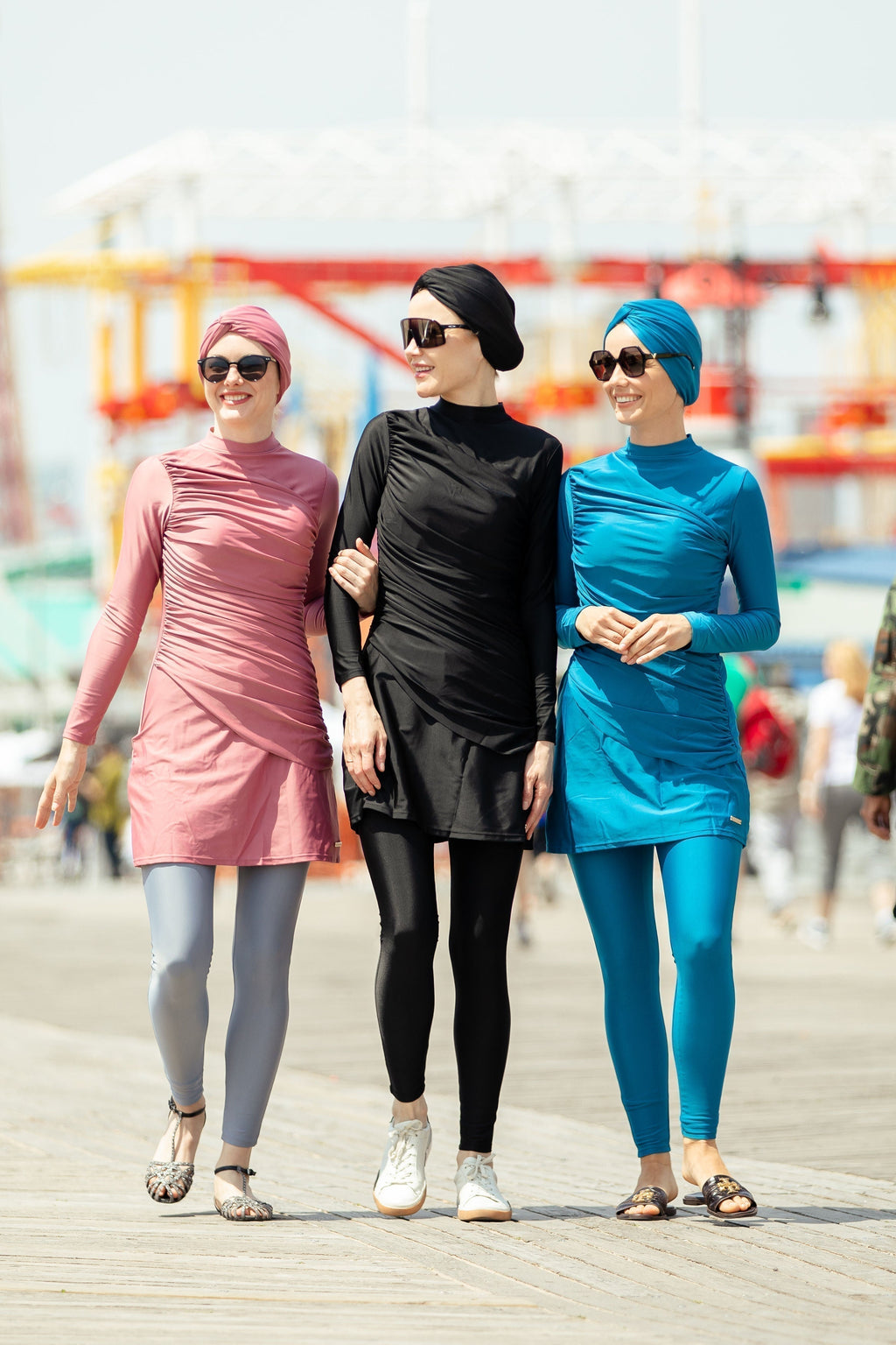 Three women modeling ruched 3-piece modest swimsuit on clearance